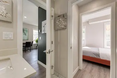 a bedroom with a bed and a bathroom at Free Heated Parking, Close to DT, Pet Friendly in Calgary