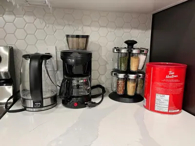 a kitchen counter with a coffee maker and other appliances at Luxurious, Centrally Located Home in Cavanagh in Edmonton