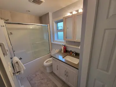 a bathroom with a shower sink and a toilet at Gladiola Bed & Breakfast in Victoria