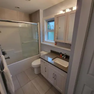 a bathroom with a toilet and a sink and a shower at Gladiola Bed & Breakfast in Victoria