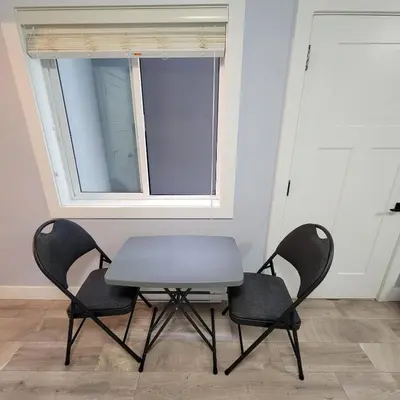 a table and two chairs in a room with a window at Gladiola Bed & Breakfast in Victoria