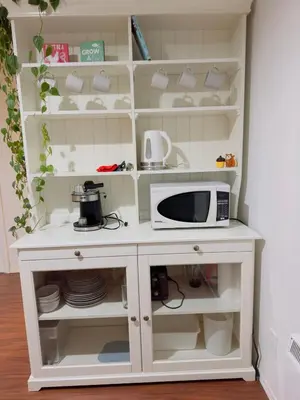 a kitchen with a white cabinet with a microwave at Covepark house in Calgary