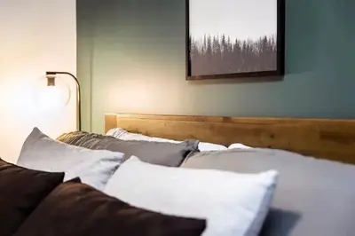 a bed with pillows on it in a room at Lucid Lemming in Revelstoke