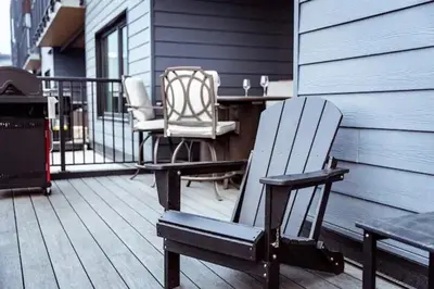 a patio with two chairs and a table on a deck at Lucid Lemming in Revelstoke