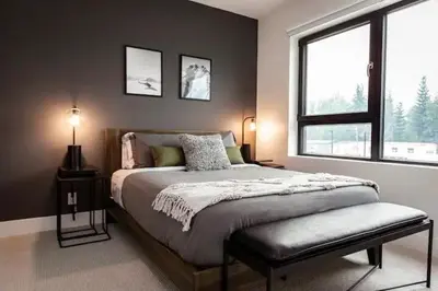 a bedroom with a large bed and a window at Lucid Lemming in Revelstoke