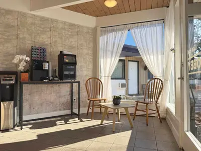 a living room with two chairs and a table at Departure Bay Motel in Nanaimo