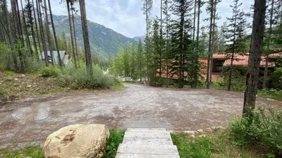 a dirt road in the middle of a forest at Ravenwood Cabin by StayIn in Panorama