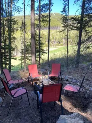 a group of chairs sitting around a fire pit at Ravenwood Cabin by StayIn in Panorama