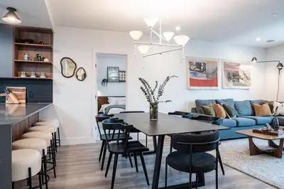 a living room with a table and a blue couch at Knuckle Hucks by Revelstoke Vacations in Revelstoke