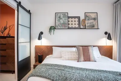 a bedroom with a bed with white sheets and pillows at Knuckle Hucks by Revelstoke Vacations in Revelstoke
