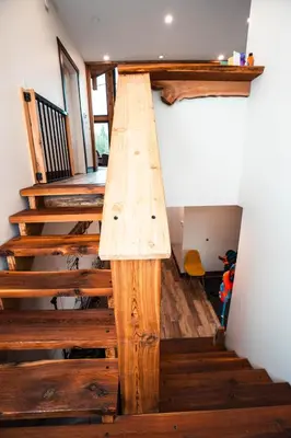 a wooden staircase in a house with wooden steps at River Safari Mountain View Suite in Blue River