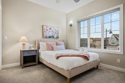 a bedroom with a large bed and a window at Golden View Manor in Calgary