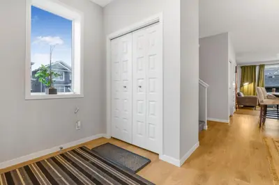 an empty living room with white walls and a large door at Private Master Bed Room SPRING in Edmonton