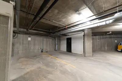 an empty parking lot in a building with a garage at Alpine Village Condo by Canadian Rockies Vacation Rentals in Canmore