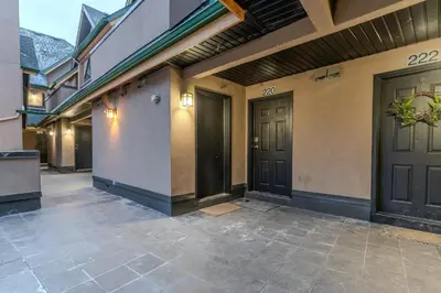 a pair of doors on a building with a courtyard at Alpine Village Condo by Canadian Rockies Vacation Rentals in Canmore