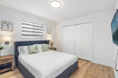 a bedroom with a bed and a window at Spacious Family Retreat Central to YVR and Downtown in Vancouver
