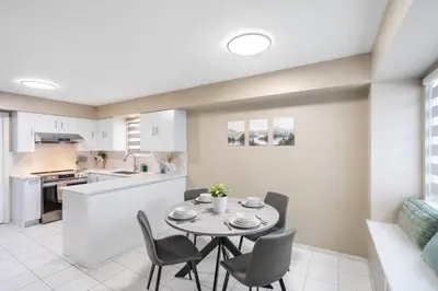 a kitchen and dining room with a table and chairs at Spacious Family Retreat Central to YVR and Downtown in Vancouver