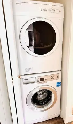 a white washer and dryer in a room at Beautiful condo beach side Yaletown in Vancouver