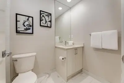 a white bathroom with a toilet and a sink at Free Parking, Pet Friendly, Close to DT in Calgary