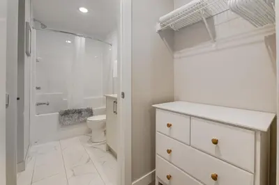 a white bathroom with a toilet and a shower at Free Parking, Pet Friendly, Close to DT in Calgary