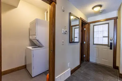 a kitchen with a white refrigerator and a door at Stunning Central Canmore Condo in Canmore