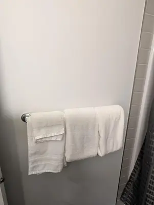 a bathroom with white towels hanging on a rack at DaraJay Cozy Home in Calgary