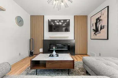 a living room with a couch and a coffee table at 5 bed Luxury Home Steps to DT, River and Hospital in Calgary
