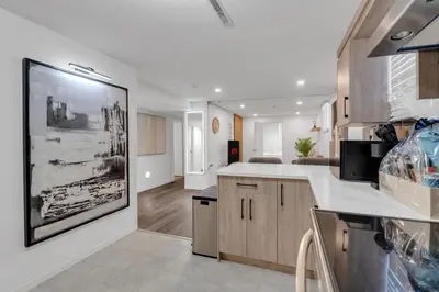 a large kitchen with a large painting on the wall at 5 bed Luxury Home Steps to DT, River and Hospital in Calgary