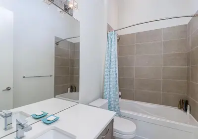 a bathroom with a sink and a toilet and a tub at Large Modern Home in Squamish in Squamish
