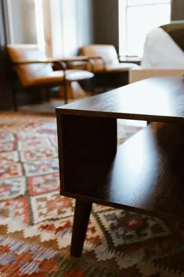 a living room with a coffee table and a rug at The Flying Steamshovel Inn in Rossland