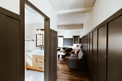 a living room with a couch and a bedroom at The Flying Steamshovel Inn in Rossland