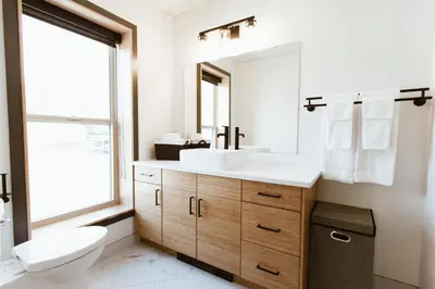 a bathroom with a white sink and a toilet at The Flying Steamshovel Inn in Rossland