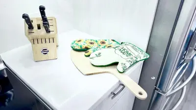 a kitchen counter with a cutting board and a knife at 3 Story Luxury Cozy Sleek Home in Edmonton