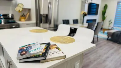 a counter with two books on top of it at 3 Story Luxury Cozy Sleek Home in Edmonton