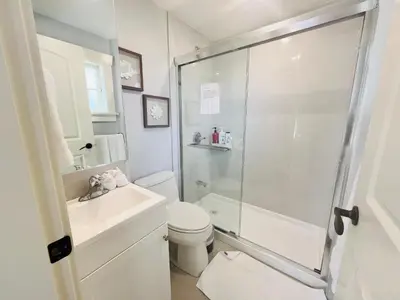 a bathroom with a shower and a toilet and a sink at West King Edward Luxury Guest Home in Vancouver
