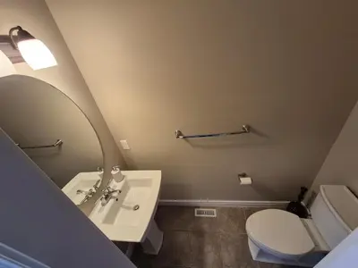 a bathroom with a sink and a toilet and a mirror at Sean Comfy Home in Edmonton