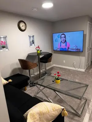 a living room with a couch and a flat screen tv at Newly Built 2-Bedroom, 2 full bath Basement Suite in Calgary
