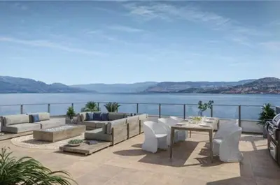 a patio with a view of the water at Beach Lake Resort in Kelowna