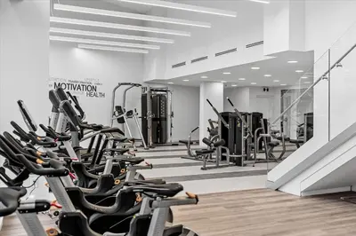 a gym with rows of exercise bikes and treadmills at Beach Lake Resort in Kelowna