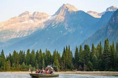 a group of people on a boat in the water at River Safari Bear Den in Blue River