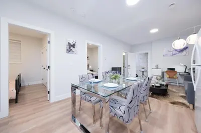 a dining room and living room with a table and chairs at Newly Built Cozy 2BR Suite Langley Event Center in Langley