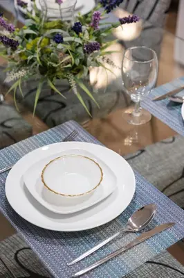a white plate on a table with a fork and spoon at Newly Built Cozy 2BR Suite Langley Event Center in Langley
