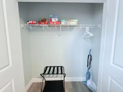 a black chair sitting in a room with a shelf at Peaks & Waters at Harrison Mills in Agassiz