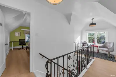 a staircase in a home with white walls and wood floors at Cozy three bedroom House in Vancouver West in Vancouver