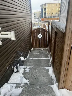a sidewalk covered in snow next to a building at 2 Bedroom Secondary Suite in Calgary