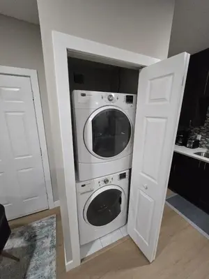 a kitchen with a washer and dryer in a room at 2 Bedroom Secondary Suite in Calgary