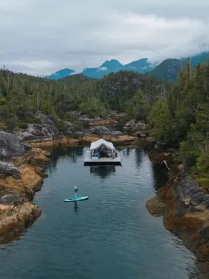 a boat on a river with a tent on it at Lux Remote Glamping Hideaway in Ucluelet