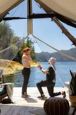 a man and a woman are in a tent at Lux Remote Glamping Hideaway in Ucluelet