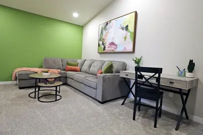 a living room with a couch and a table at Edgemont Escape Large Groups, River Cree, WEM, Disney in Edmonton