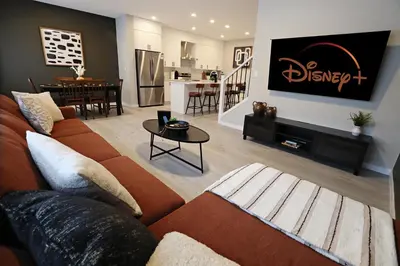 a living room with a couch and a table at Edgemont Retreat, Groups, River Cree, WEM, Disney in Edmonton